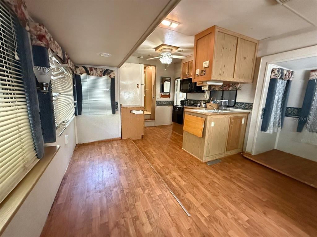 3000 Clarcona Road, Unit 419 Apopka, FL 32703 - Photo 2 of 12 a kitchen with stainless steel appliances wooden floors and large window