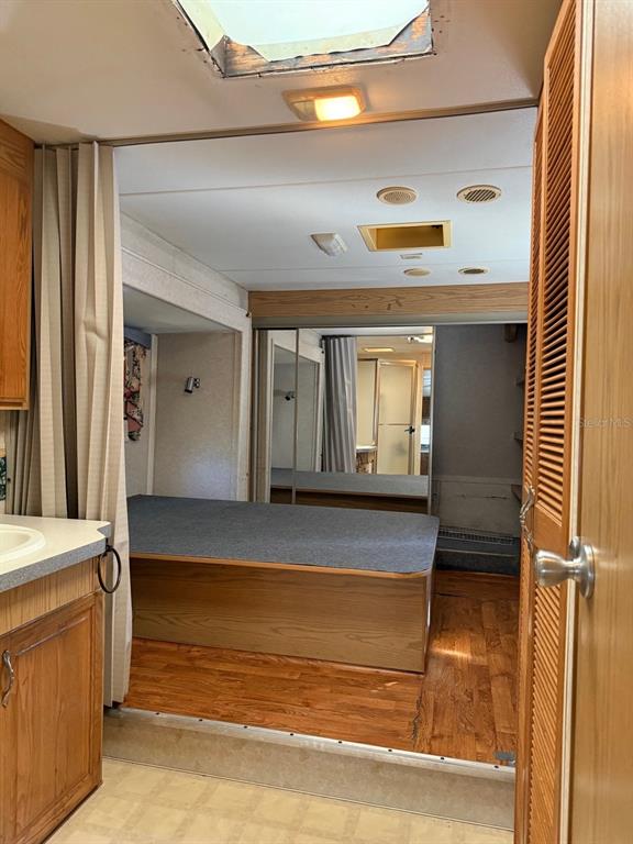 3000 Clarcona Road, Unit 419 Apopka, FL 32703 - Photo 5 of 12 a view of a hallway with entryway wooden floor and door