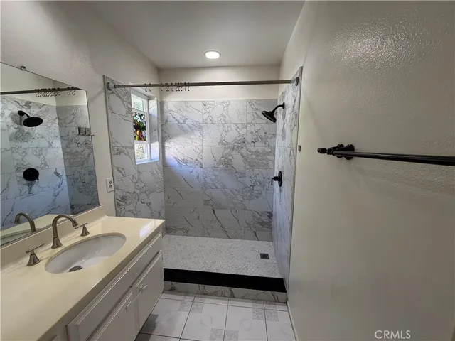 a view of a hallway and a livingroom with wooden floor
