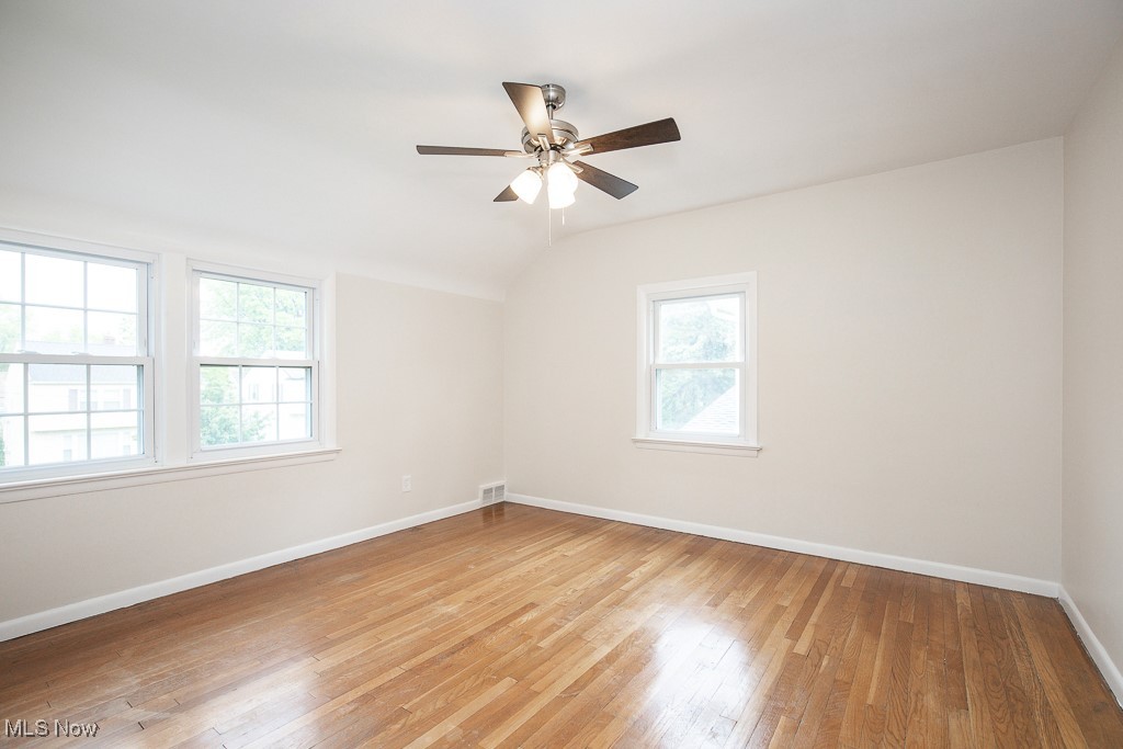 3762 Covington Road South Euclid, OH 44121 - Photo 15 of 31 Empty room with light wood-style floors, vaulted ceiling, and ceiling fan