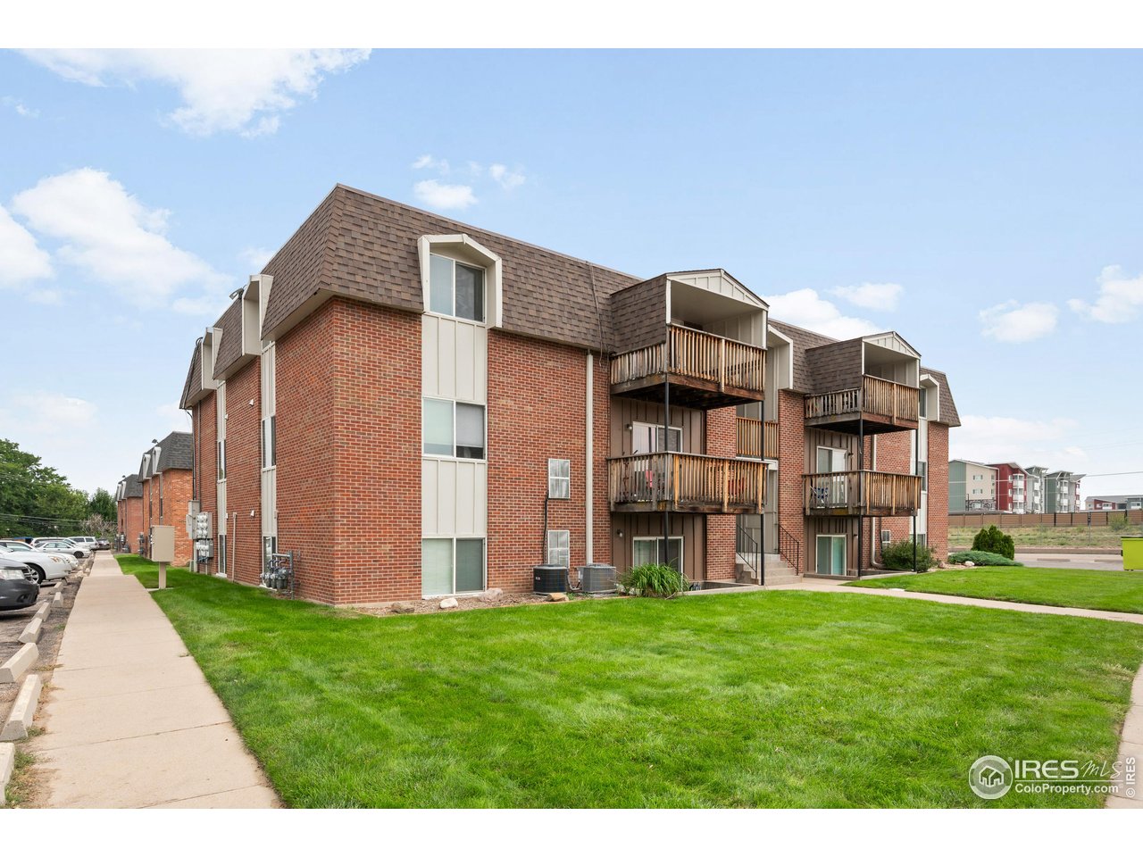 a view of a big house with a big yard plants and large trees