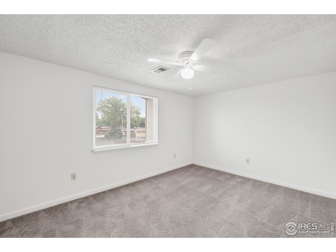 1817 26th Street Greeley, CO 80631 - Photo 18 of 29 a view of an empty room with a window