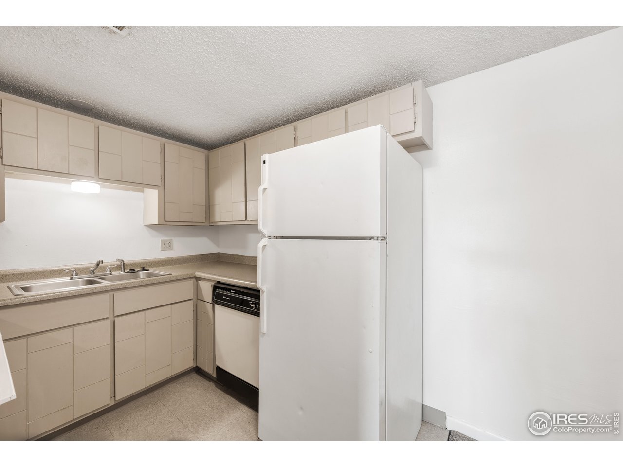 1817 26th Street Greeley, CO 80631 - Photo 23 of 29 a kitchen with stainless steel appliances granite countertop white refrigerator stove a sink and dishwasher