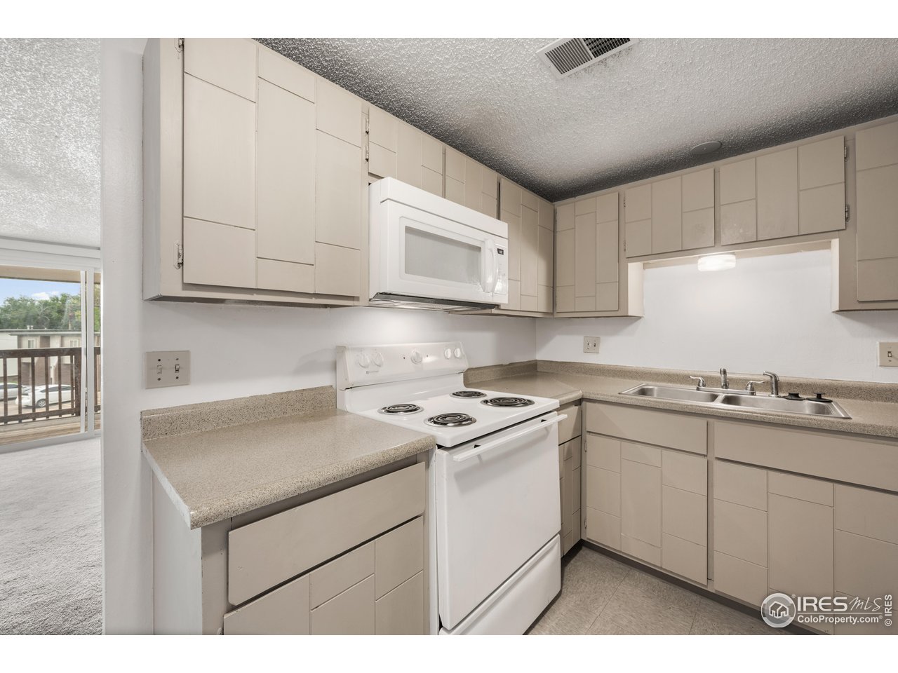 1817 26th Street Greeley, CO 80631 - Photo 24 of 29 a kitchen with stainless steel appliances granite countertop a sink stove and cabinets