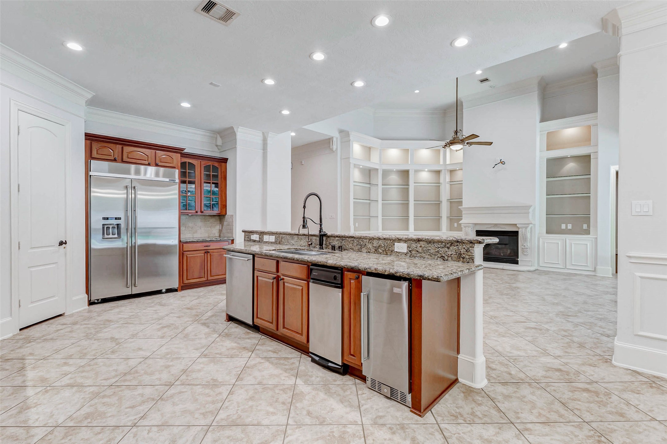 3509 Mirror Court Spring, TX 77388 - Photo 11 of 45 The kitchen offers an impressive amount of storage and prep space, highlighted by a professional-grade stainless steel refrigerator and freezer set into custom cabinetry.