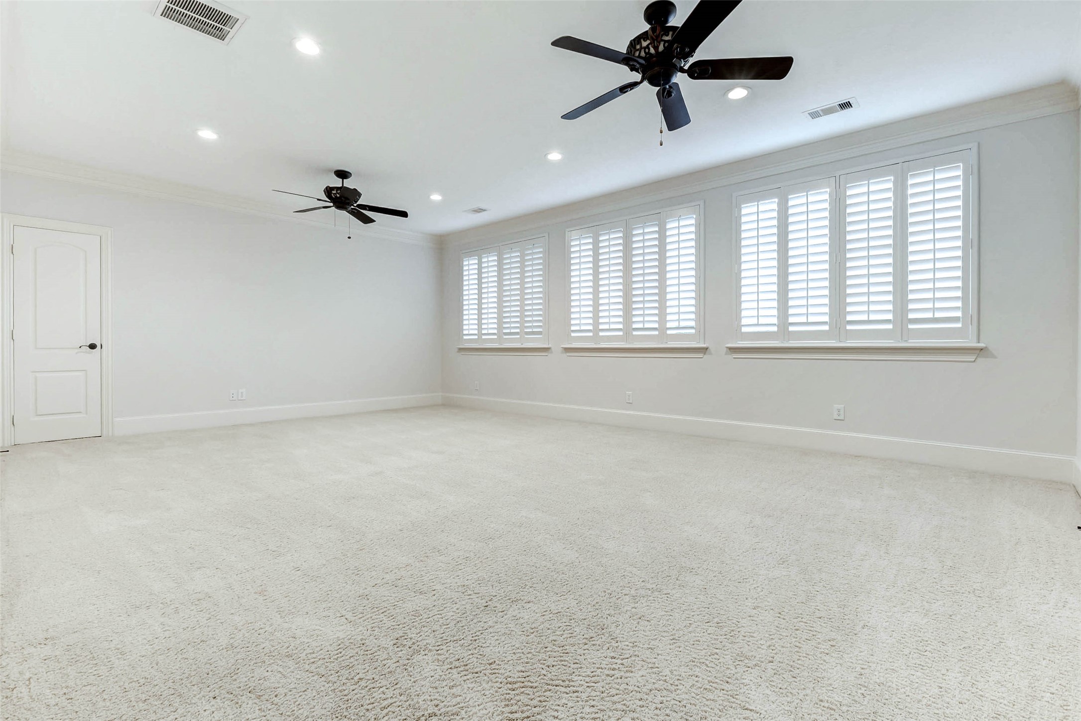 3509 Mirror Court Spring, TX 77388 - Photo 29 of 45 The upstairs bonus room provides an expansive, light-filled setting ideal for a bedroom, a second game room, home gym, media lounge, or playroom—offering endless flexibility to suit your lifestyle. A wall of windows with plantation shutters floods the space with natural light.