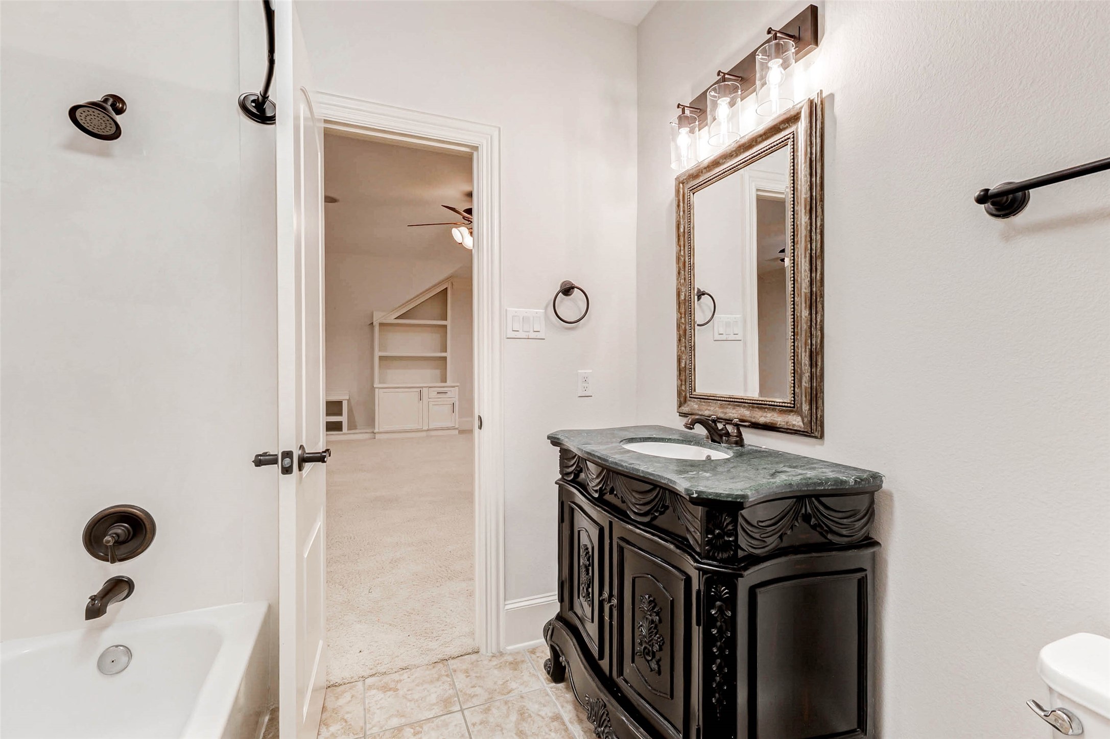 3509 Mirror Court Spring, TX 77388 - Photo 31 of 45 The full bathroom upstairs offers a stylish vanity with rich detailing, updated lighting, and a tub/shower combination. Conveniently located just off the game room for easy access.