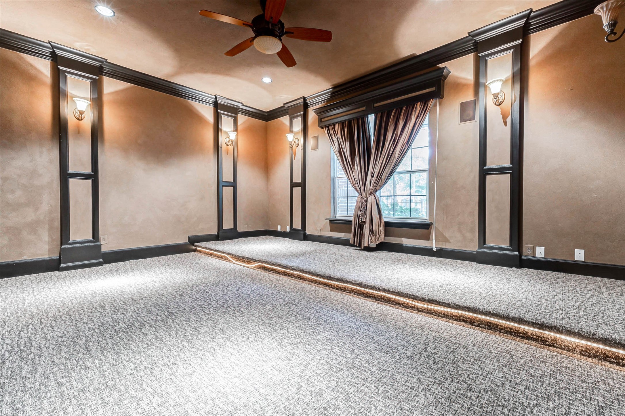 3509 Mirror Court Spring, TX 77388 - Photo 6 of 45 The dedicated media room offers a true theater experience with tiered seating, soft wall lighting, custom millwork, and plush carpeting.