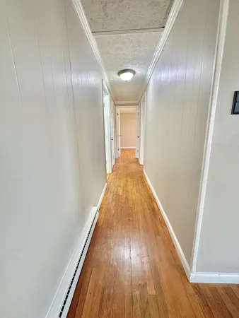 a view of hallway with wooden floor