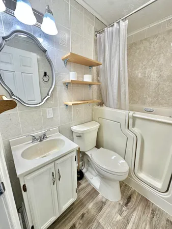 a bathroom with a sink toilet and shower