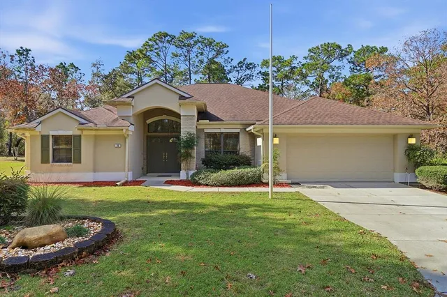 a front view of a house with a garden and plants