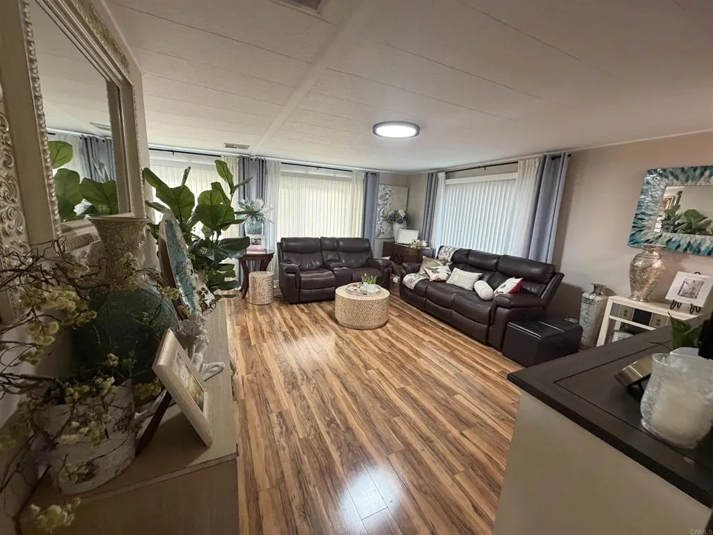 8301 Mission Gorge Road, Unit 162 Santee, CA 92071 - Photo 15 of 65 a living room with furniture floor to ceiling window and wooden floor