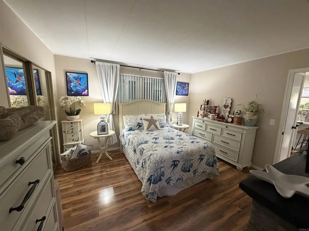 8301 Mission Gorge Road, Unit 162 Santee, CA 92071 - Photo 19 of 65 a bed room with a bed and a dresser