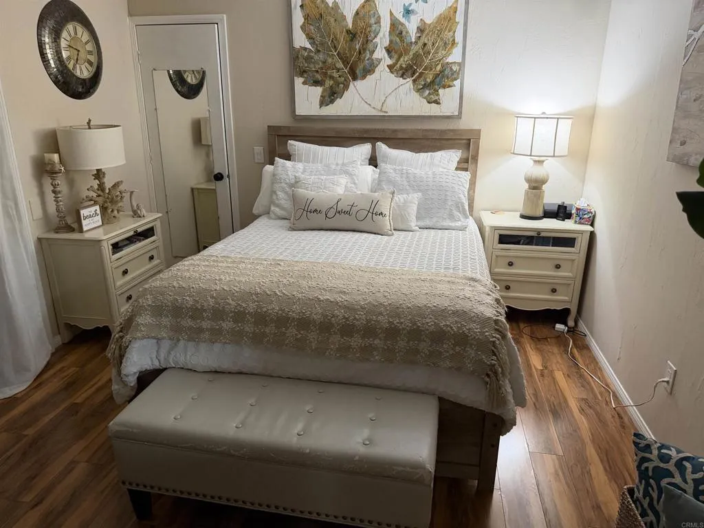 8301 Mission Gorge Road, Unit 162 Santee, CA 92071 - Photo 22 of 65 a bedroom with a bed and a chandelier