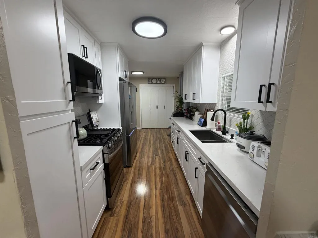 8301 Mission Gorge Road, Unit 162 Santee, CA 92071 - Photo 5 of 65 a kitchen with sink stove and refrigerator