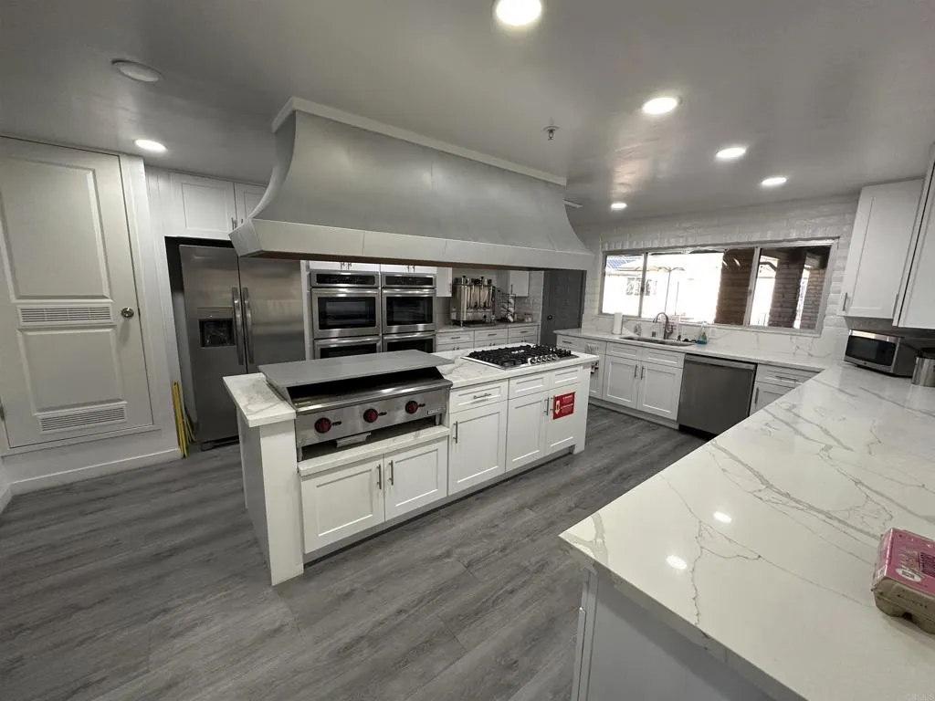 8301 Mission Gorge Road, Unit 162 Santee, CA 92071 - Photo 58 of 65 a kitchen with a sink stainless steel appliances and cabinets