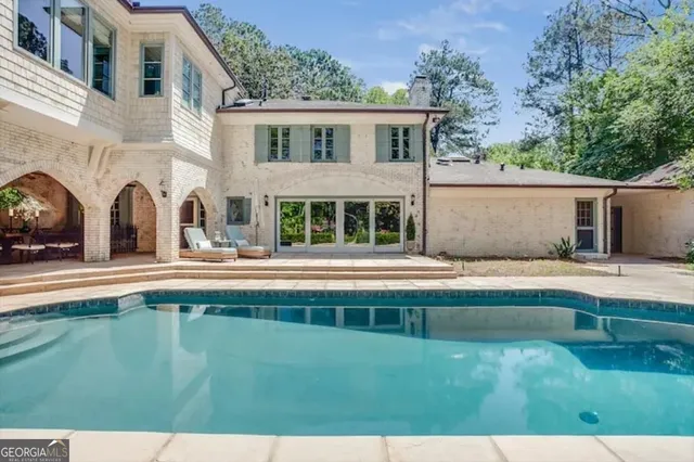 a view of house with a swimming pool