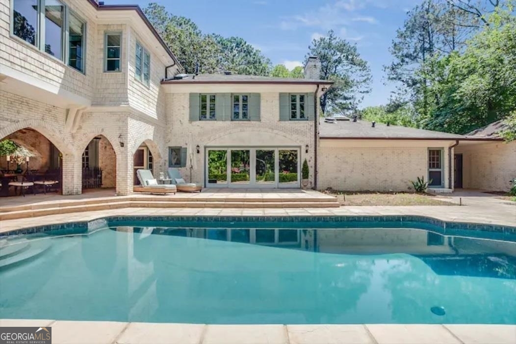 a view of house with a swimming pool