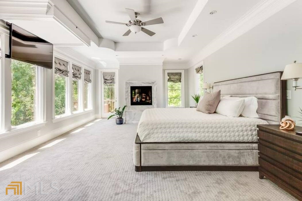 2510 Bohler Road Northwest Atlanta, GA 30327 - Photo 13 of 47 a spacious bedroom with a large bed and a chandelier