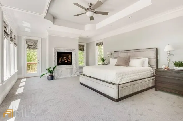 a spacious bedroom with a bed and a fireplace