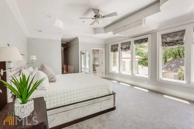 a living room with furniture a large window and a chandelier