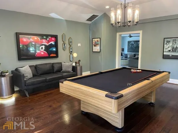 a living room with pool table and a flat screen tv
