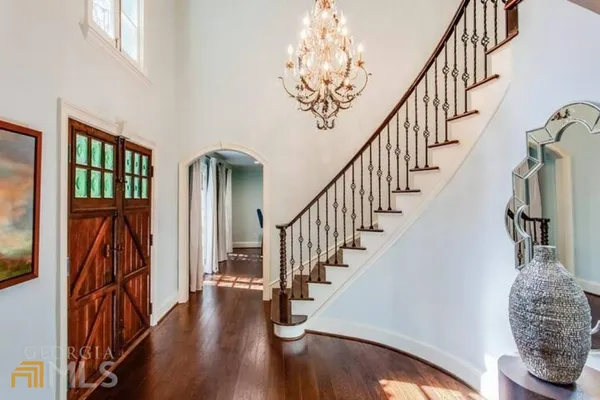 a view of entryway and hall with wooden floor