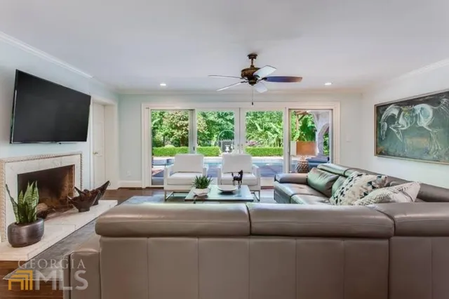 a living room with furniture a fireplace and a flat screen tv