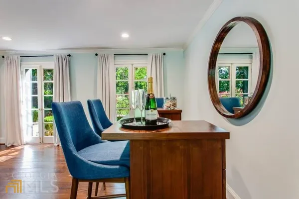 a dining room with furniture and a window