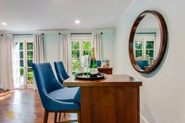 a dining room with furniture and a window