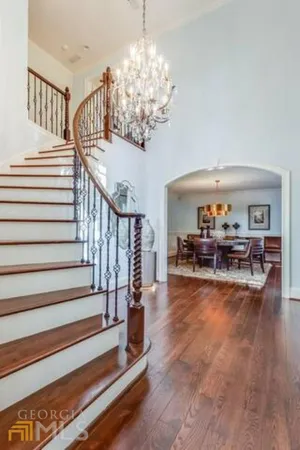 a living room with fireplace furniture and a chandelier