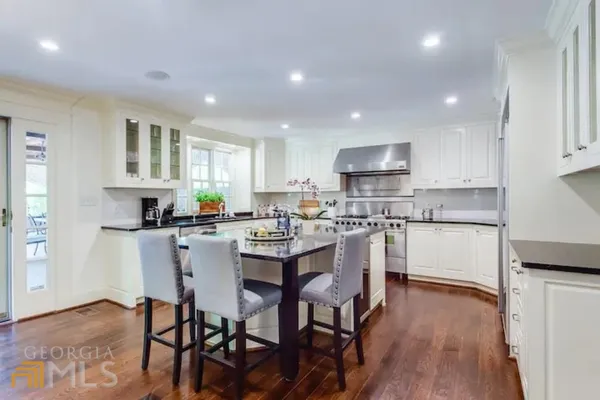 a kitchen with a table and chairs in it