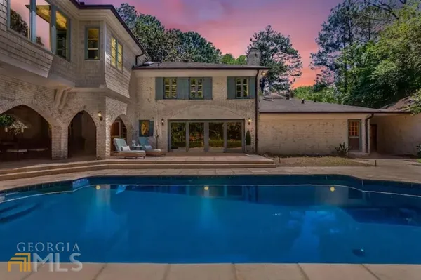 a view of house with swimming pool