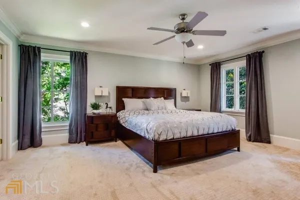 a bedroom with a large bed and a large window