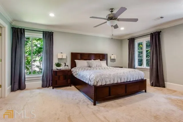 a bedroom with a large bed and a large window