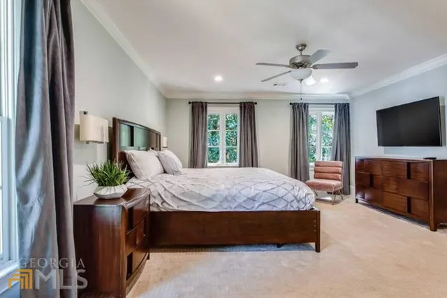 a bedroom with a bed and flat screen tv