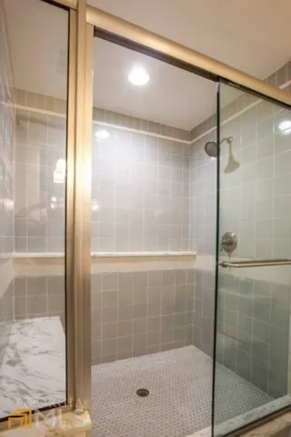a bathroom with a glass shower door