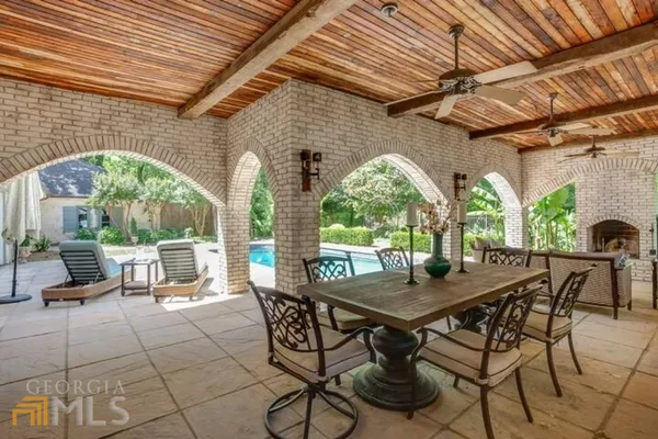 a view of a patio with table and chairs and potted plants