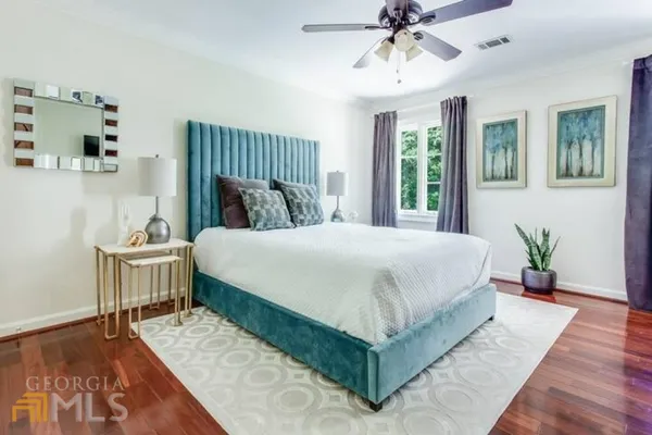 a spacious bedroom with a bed and a chandelier
