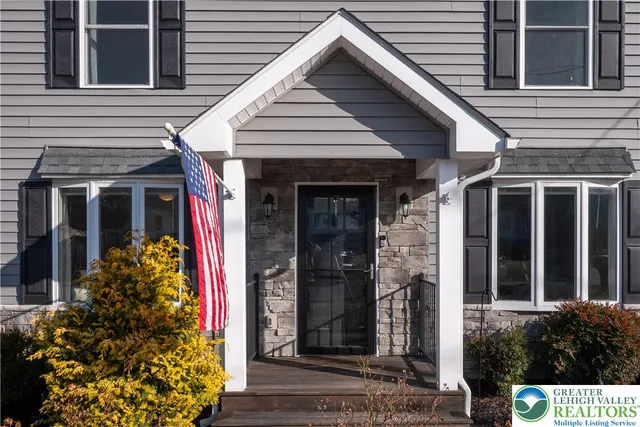a view of an entryway with wooden floor and windows