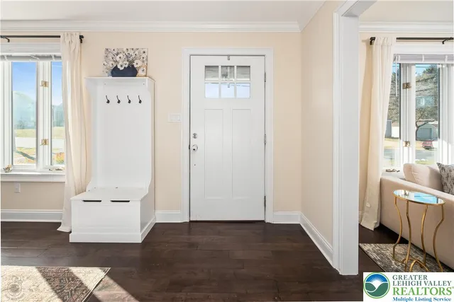 a living room with dining table and a couches