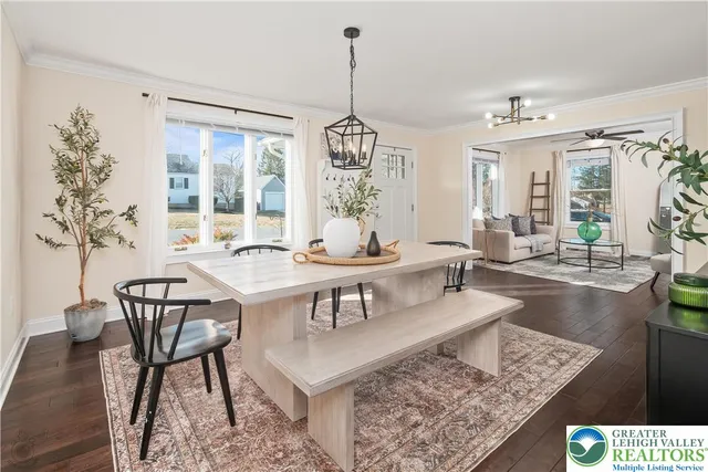 a dining room with furniture a rug and wooden floor