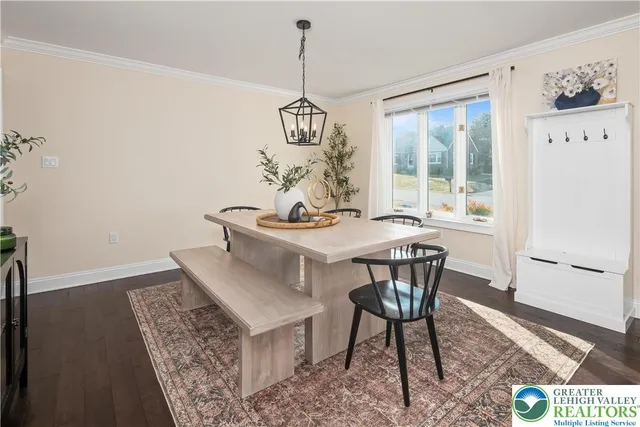 a living room with furniture a flat screen tv and a large window