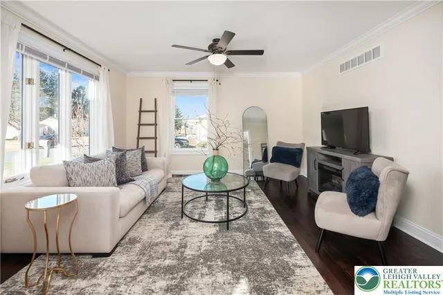 a dining room filled chandelier and wooden floor