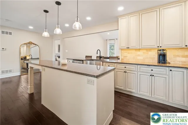 a kitchen with stainless steel appliances a refrigerator stove and microwave