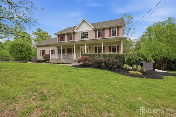 a front view of house with yard and green space