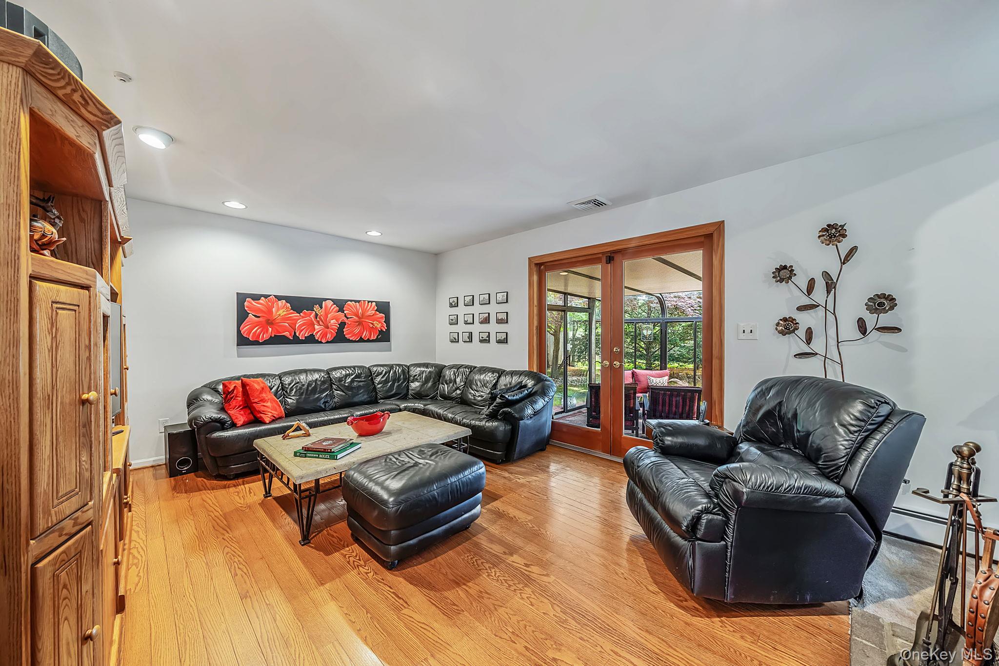 96 Fulton Boulevard Commack, NY 11725 - Photo 25 of 41 a living room with furniture flat screen tv and a large window