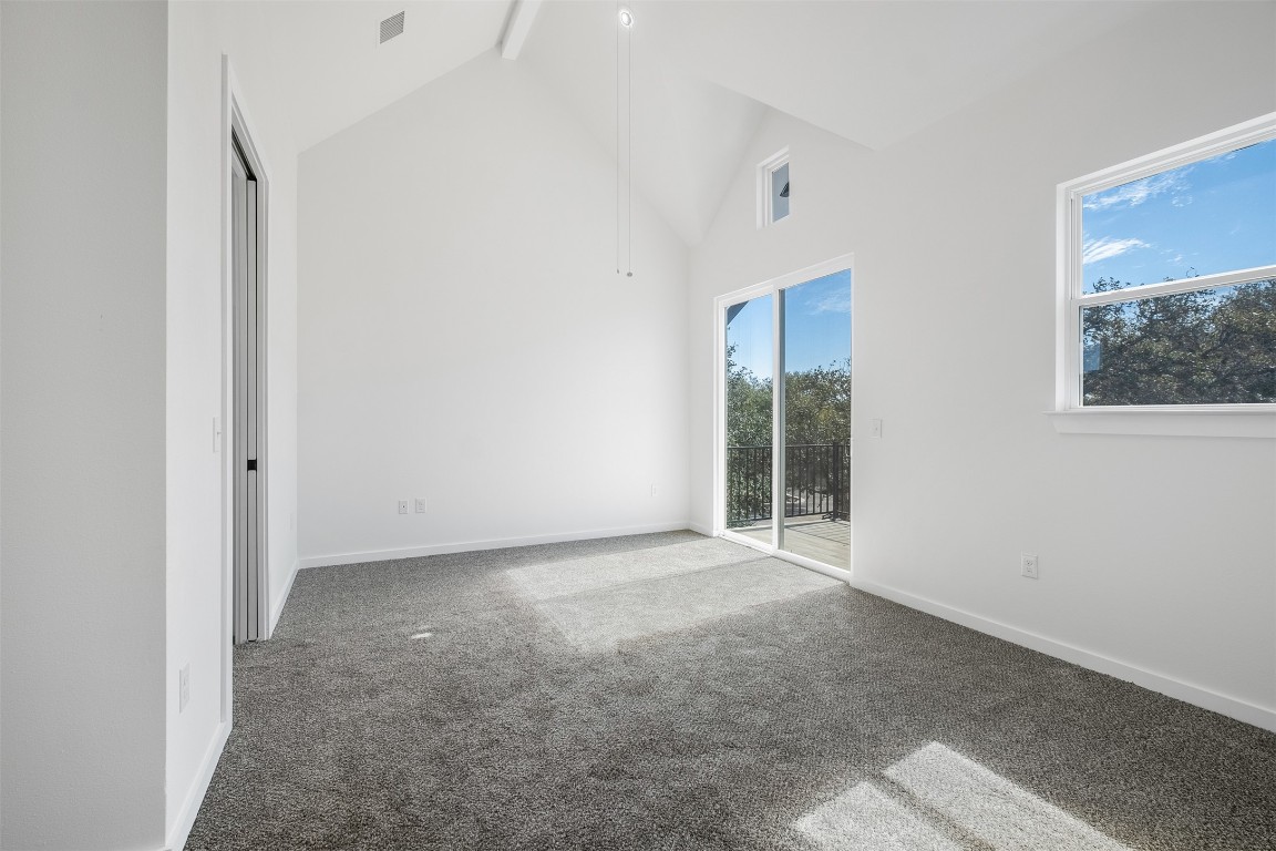 255 Lourdes Court, Unit A Dripping Springs, TX 78620 - Photo 12 of 27 an empty room with windows