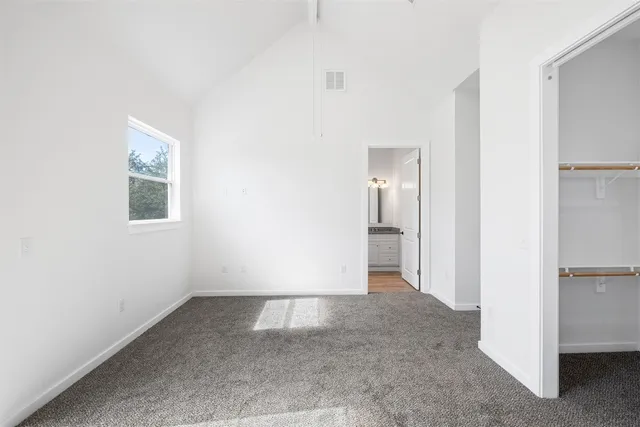 a view of walk in closet with empty racks