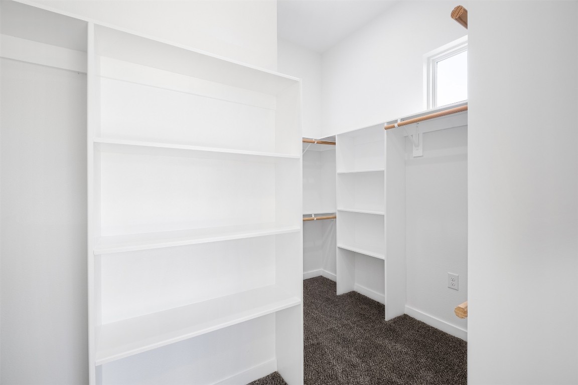 255 Lourdes Court, Unit A Dripping Springs, TX 78620 - Photo 14 of 27 a view of walk in closet with empty racks